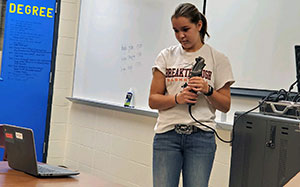 young woman with microphone and computer