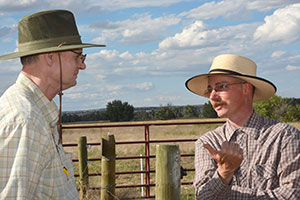 Two men talking outside