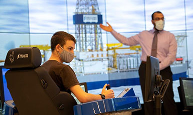 man sitting in a simulation control chair