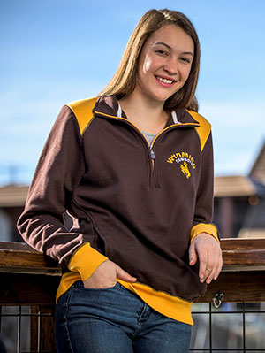 woman leaning against a railing outside