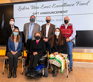 group of people posing in front of a large banner