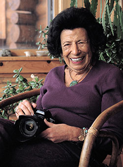 woman sitting and holding a camera