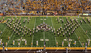 marching band forming the letter W on a football field