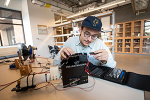 person working with electronics gear