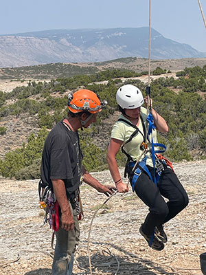 person in climbing gear learning to use ropes
