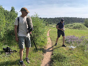 two people with drones