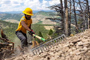 man in a hard hat working on a hillside