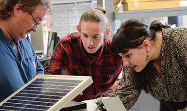 three people working together on something