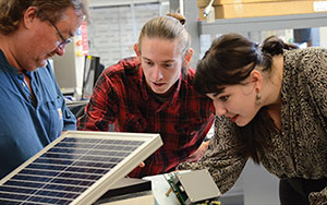 three people working together on something