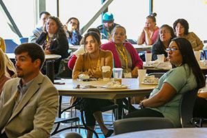 people seated at tables for an event