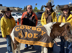 group of people with a pony