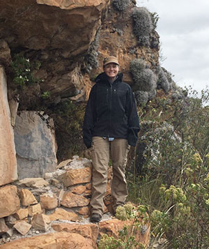 woman standing on rock ledge