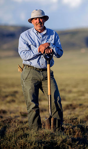 man outdoors with shovel