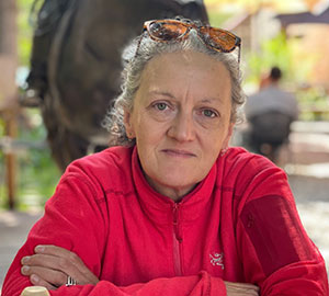 woman sitting and leaning on crossed arms