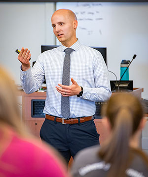 man speaking in front of a class