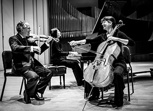 three people playing musical instruments