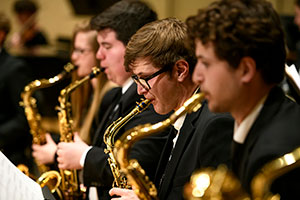 row of people playing saxophones