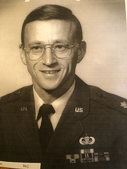 black and white photo of man in military uniform