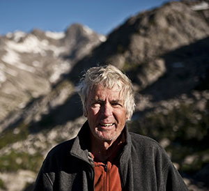 man standing in front of mountains