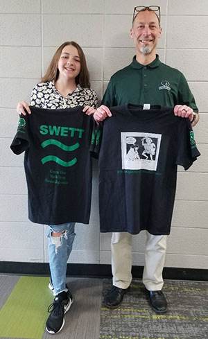 girl and man holding t-shirts