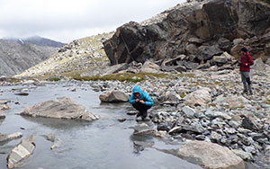 two people on a rocky stream bank