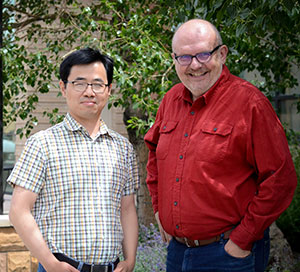 two men standing outside