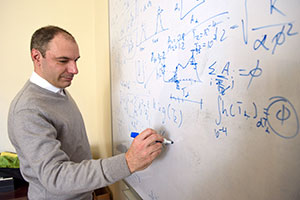 man writing on a whiteboard