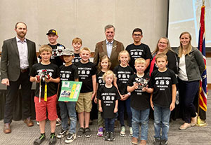 children in matching t-shirts posing as a group