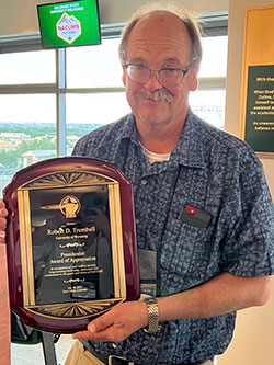 man holding an award