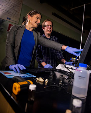 two people looking at a computer moniter