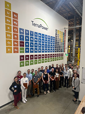 group of people standing beneath a wall sign