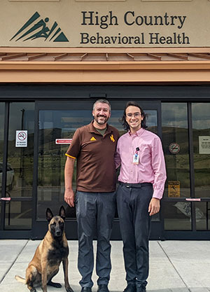 two men standing in front of a building