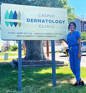 woman standing beside a sign