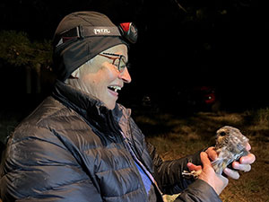 woman with an owl at night