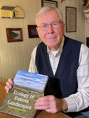 man holding up a book