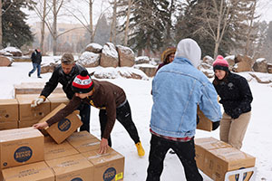 people unloading boxes in the snow