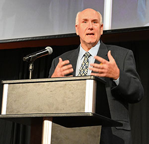 man at a podium with a microphone