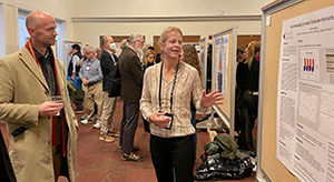 woman explaining poster to someone