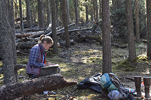 woman sitting in the forest