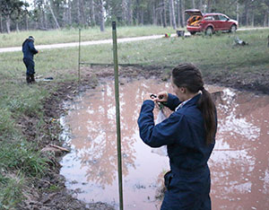 people seeting up netting in a giant puddle