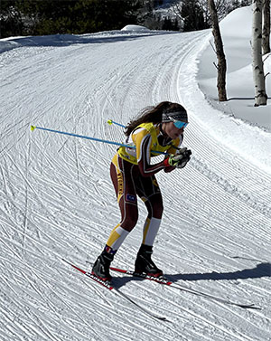 woman Nordic skiing down a hill