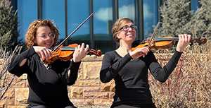 two women holding violins