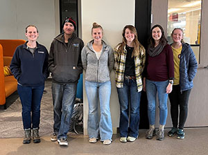 group of people standing in a hallway