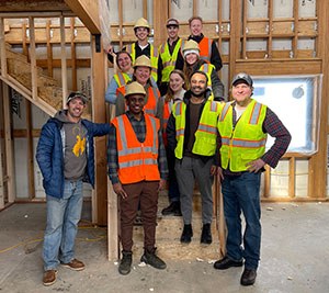 group of people standing inside unfinished house