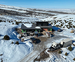 house on snowy hill, seen from above