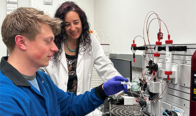 man and woman working with lab equipment