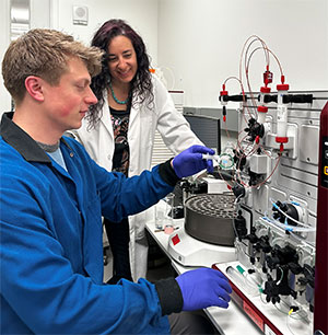 man and woman working with lab equipment