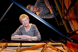 woman sitting at a piano