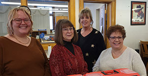 four people posing together