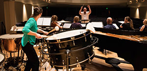 person playing a huge drum on a stage